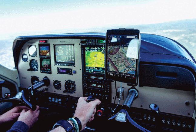 The picture shows the cockpit of a general aviation aircraft. Most of the instruments are analog. Key exception: A standard consumer tablet that the pilot brought on board and that displays the current position of the aircraft. In fact, consumer tablets with navigation apps are usually the most advanced technology support that general aviation pilots have.